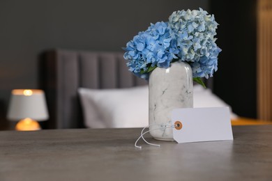 Photo of Welcome. Blank card and hydrangea flowers on grey table indoors, space for text