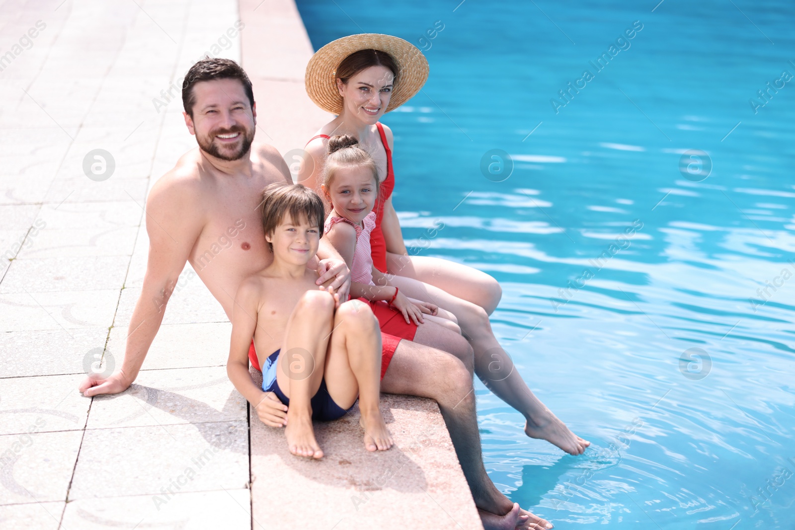 Happy family at poolside outdoors on sunny day, space for text Photo of Happy family at poolside outdoors on sunny day, space for text