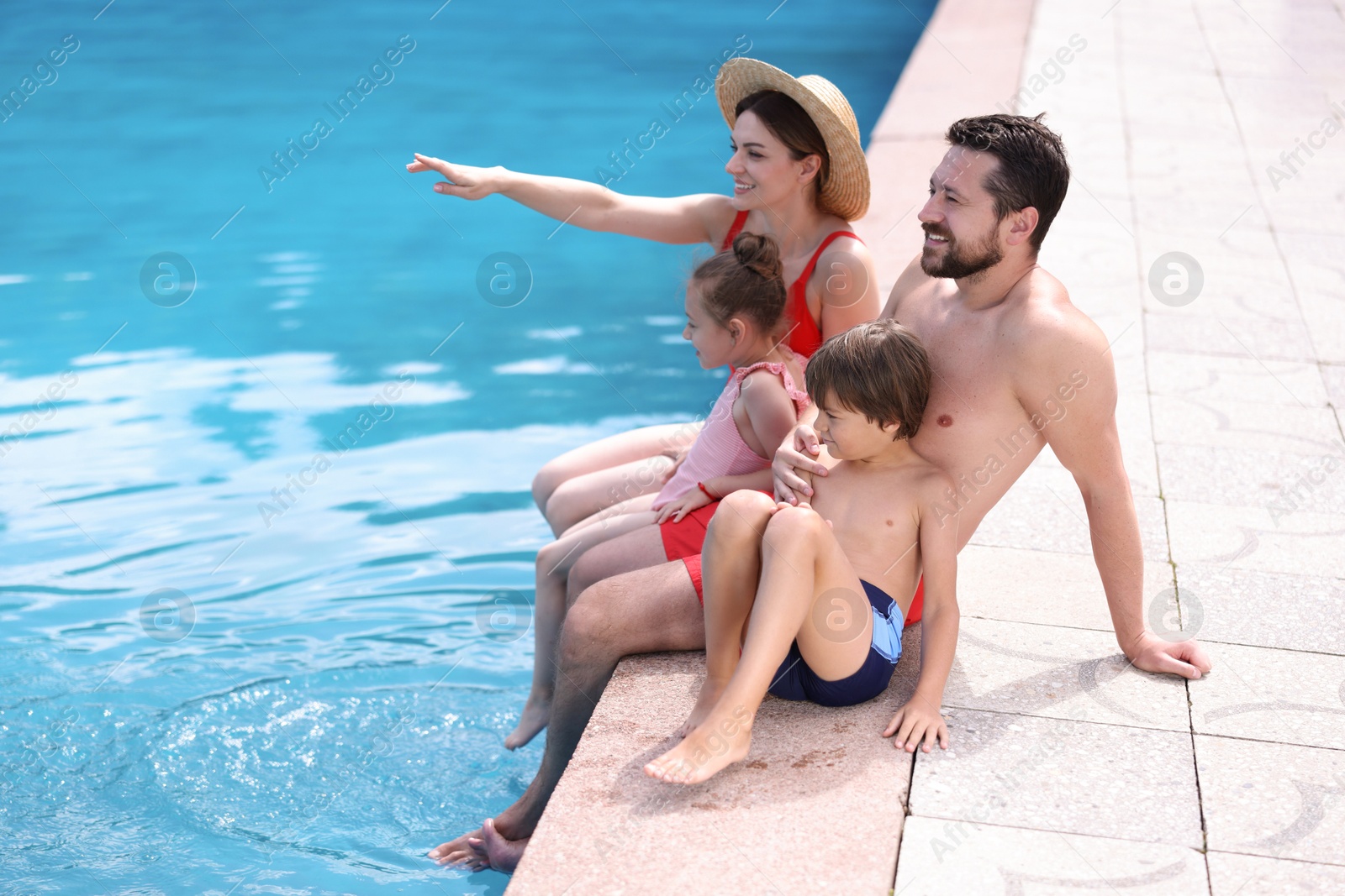 Happy family at poolside outdoors on sunny day, space for text Photo of Happy family at poolside outdoors on sunny day, space for text