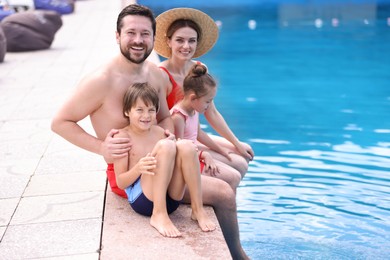 Photo of Happy family at poolside outdoors on sunny day