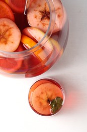 Photo of Tasty fruity punch on white table, top view. Refreshing drink