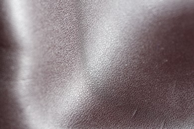Photo of Texture of natural leather as background, closeup