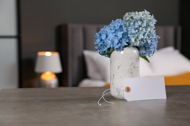 Photo of Welcome. Blank card and hydrangea flowers on grey table indoors, space for text
