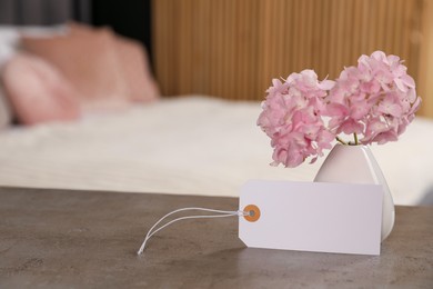 Photo of Welcome. Blank card and hydrangea flowers on grey table indoors, space for text