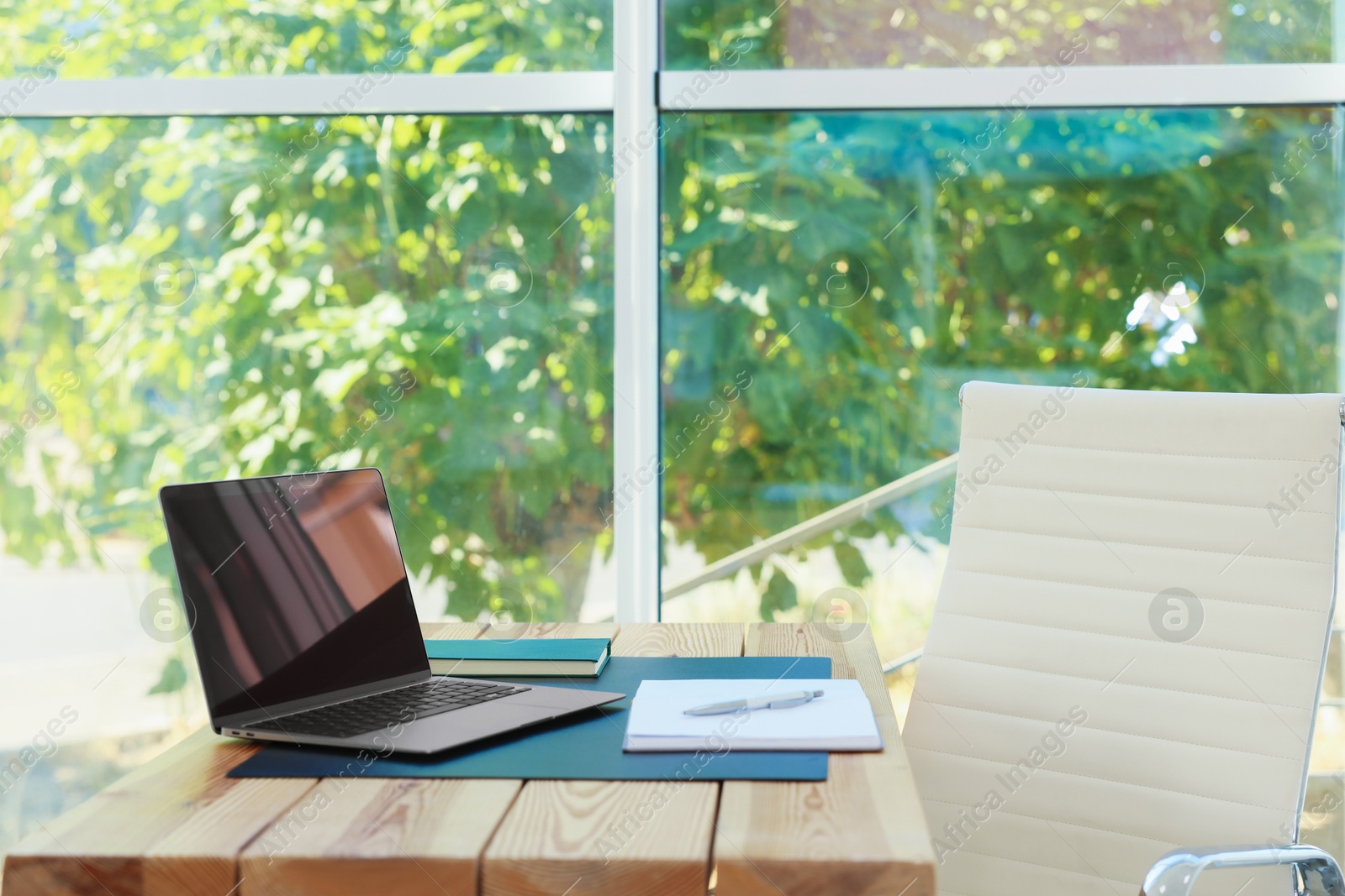 Photo of Home workplace. Laptop and stationery on wooden table