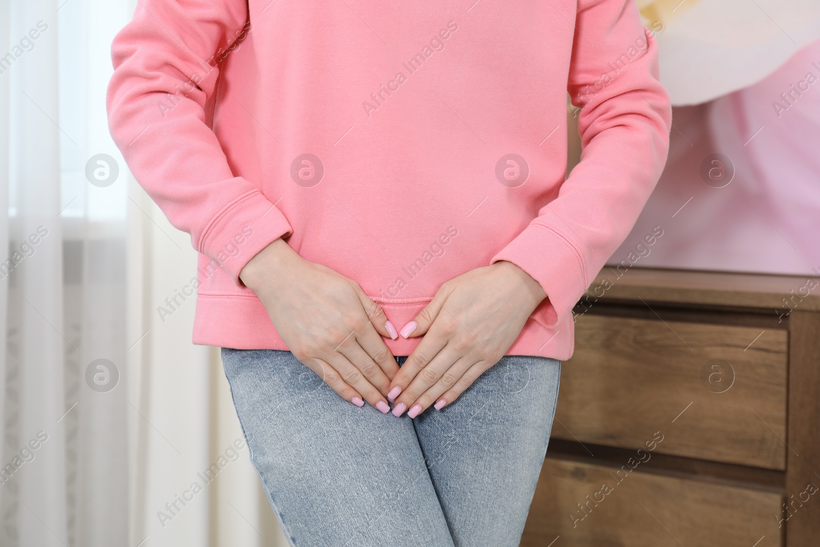 Photo of Woman suffering from cystitis symptoms at home, closeup