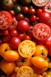 Photo of Different ripe juicy tomatoes as background, closeup