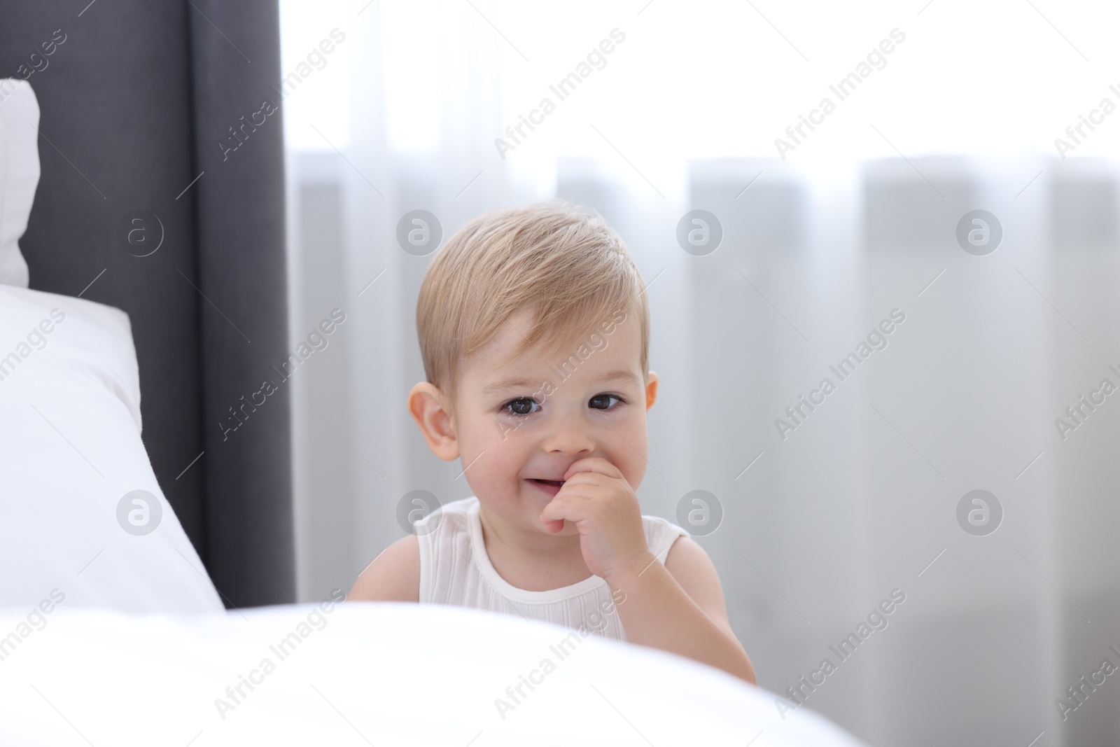 Cute little baby near bed at home Photo of Cute little baby near bed at home