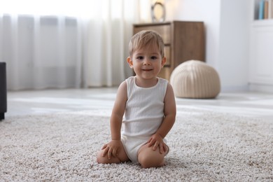 Photo of Cute little baby on floor at home