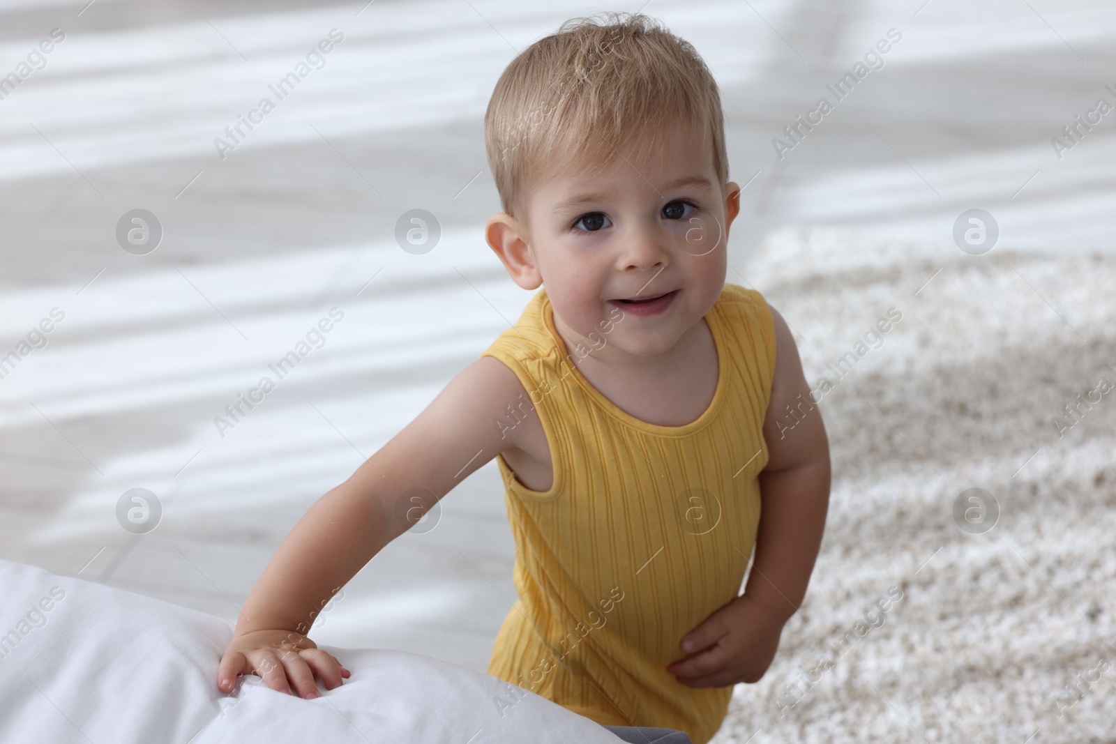 Photo of Cute little baby in onesie at home