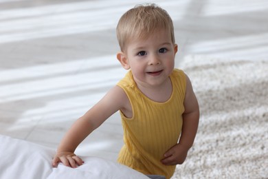 Photo of Cute little baby in onesie at home