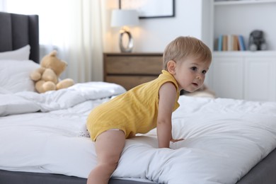 Photo of Cute little baby on bed at home