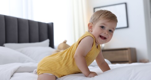 Photo of Cute little baby on bed at home