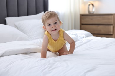Photo of Cute little baby on bed at home