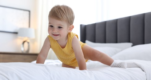 Photo of Cute little baby on bed at home