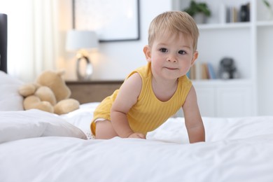 Photo of Cute little baby on bed at home