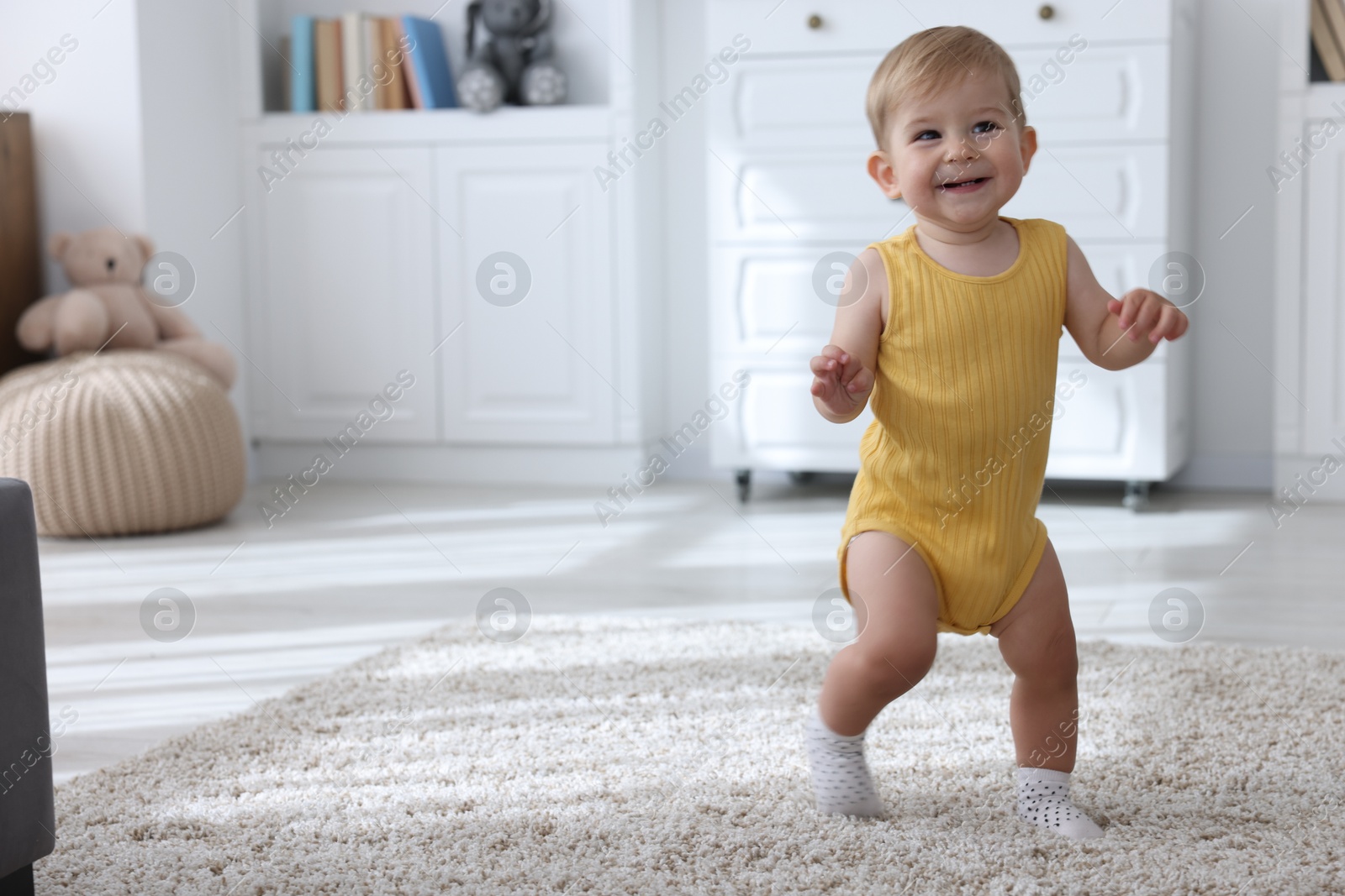 Cute little baby in onesie at home, space for text Photo of Cute little baby in onesie at home, space for text