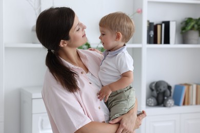 Photo of Mother with her cute little baby at home