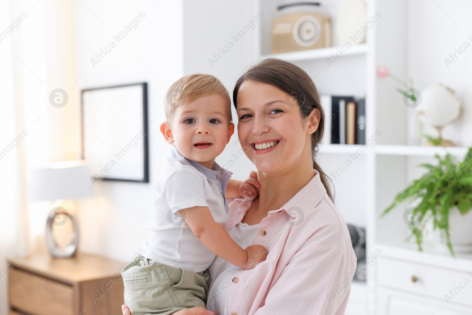 Photo of Mother with her cute little baby at home