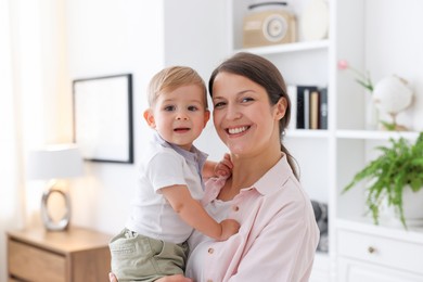 Photo of Mother with her cute little baby at home