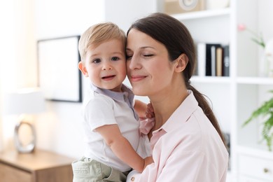 Photo of Mother with her cute little baby at home