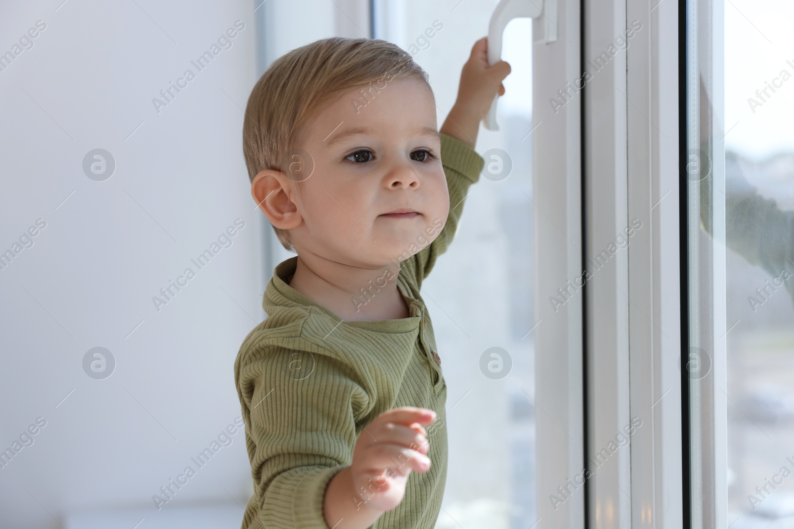 Cute little baby near window at home Photo of Cute little baby near window at home