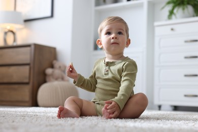 Photo of Cute little baby on floor at home