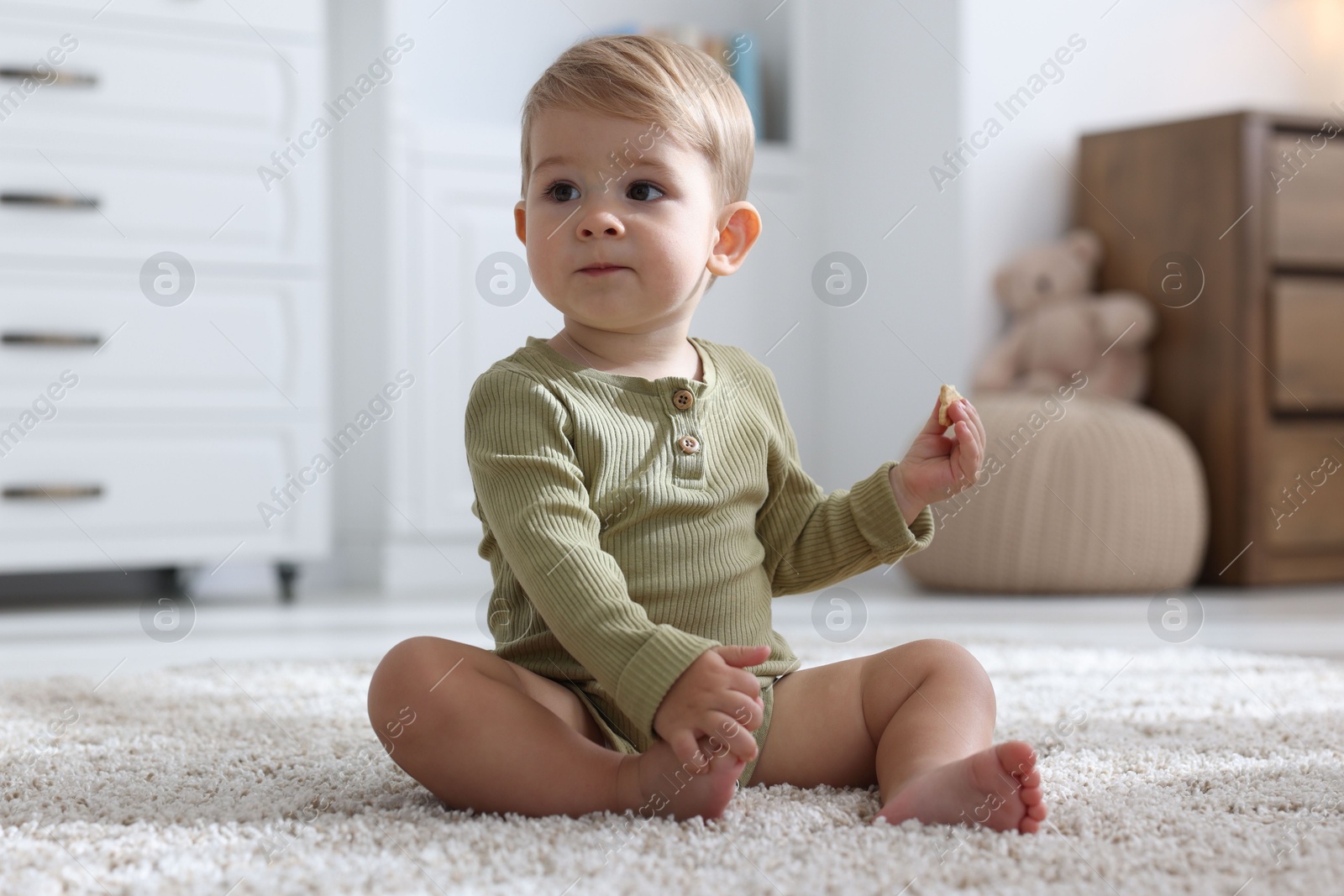 Cute little baby on floor at home Photo of Cute little baby on floor at home