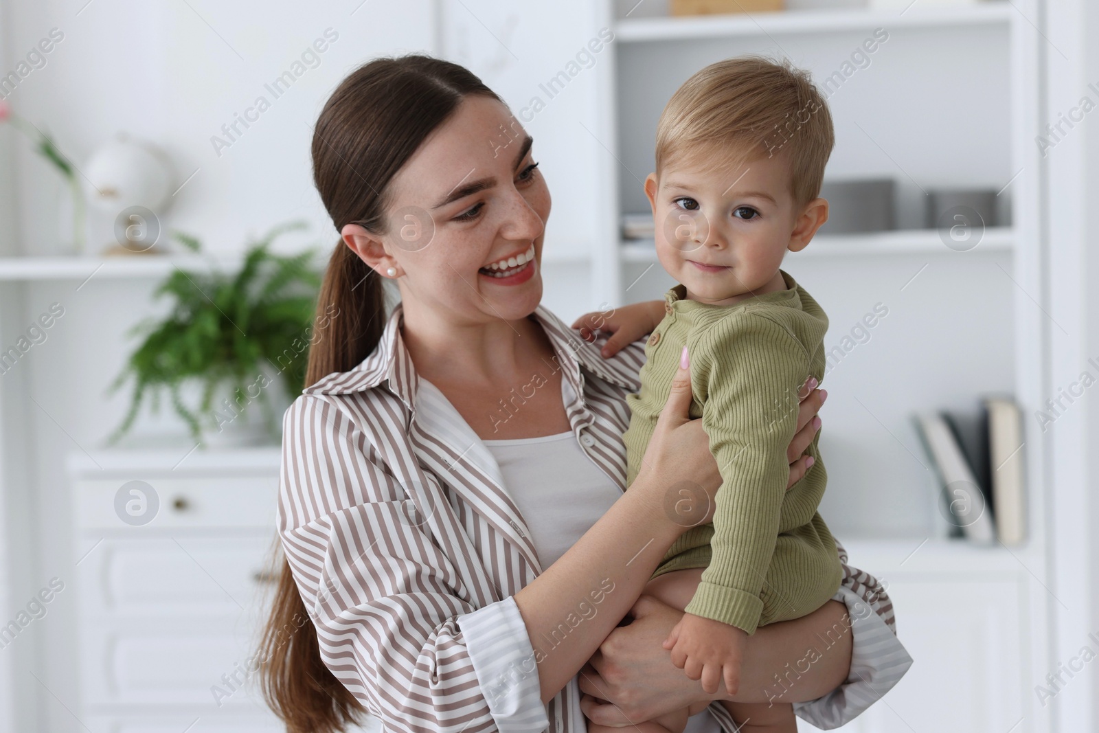 Photo of Mother with her cute little baby at home