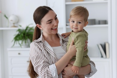 Photo of Mother with her cute little baby at home