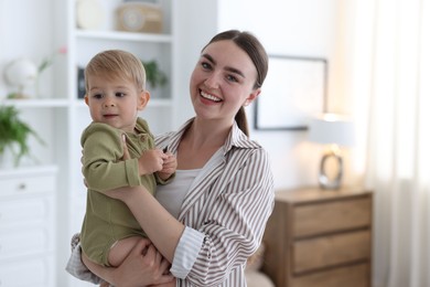 Photo of Mother with her cute little baby at home, space for text