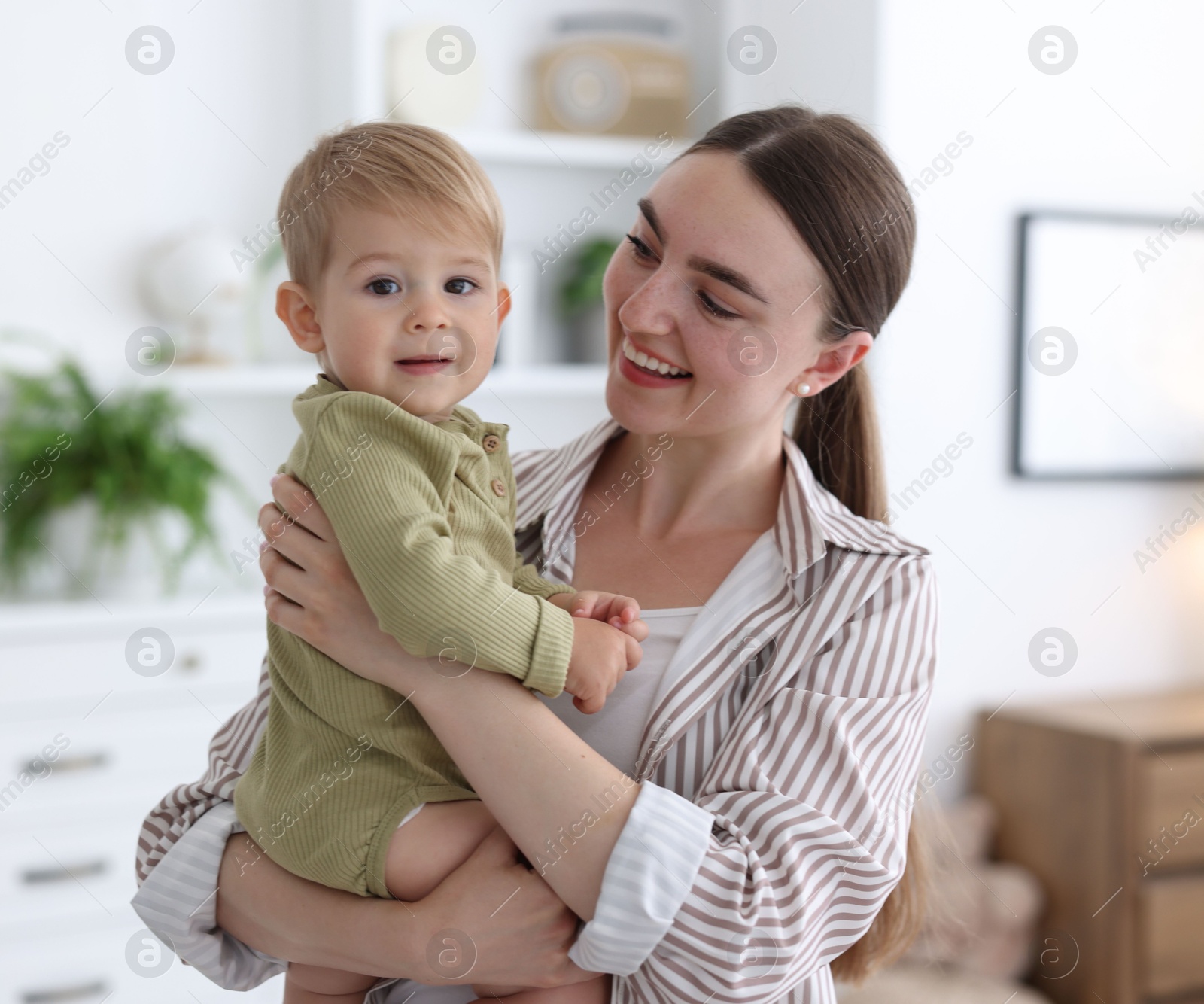 Photo of Mother with her cute little baby at home