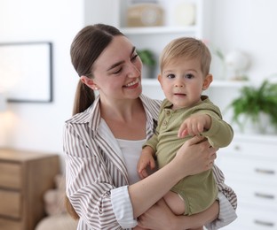 Photo of Mother with her cute little baby at home