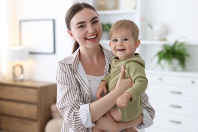 Photo of Mother with her cute little baby at home