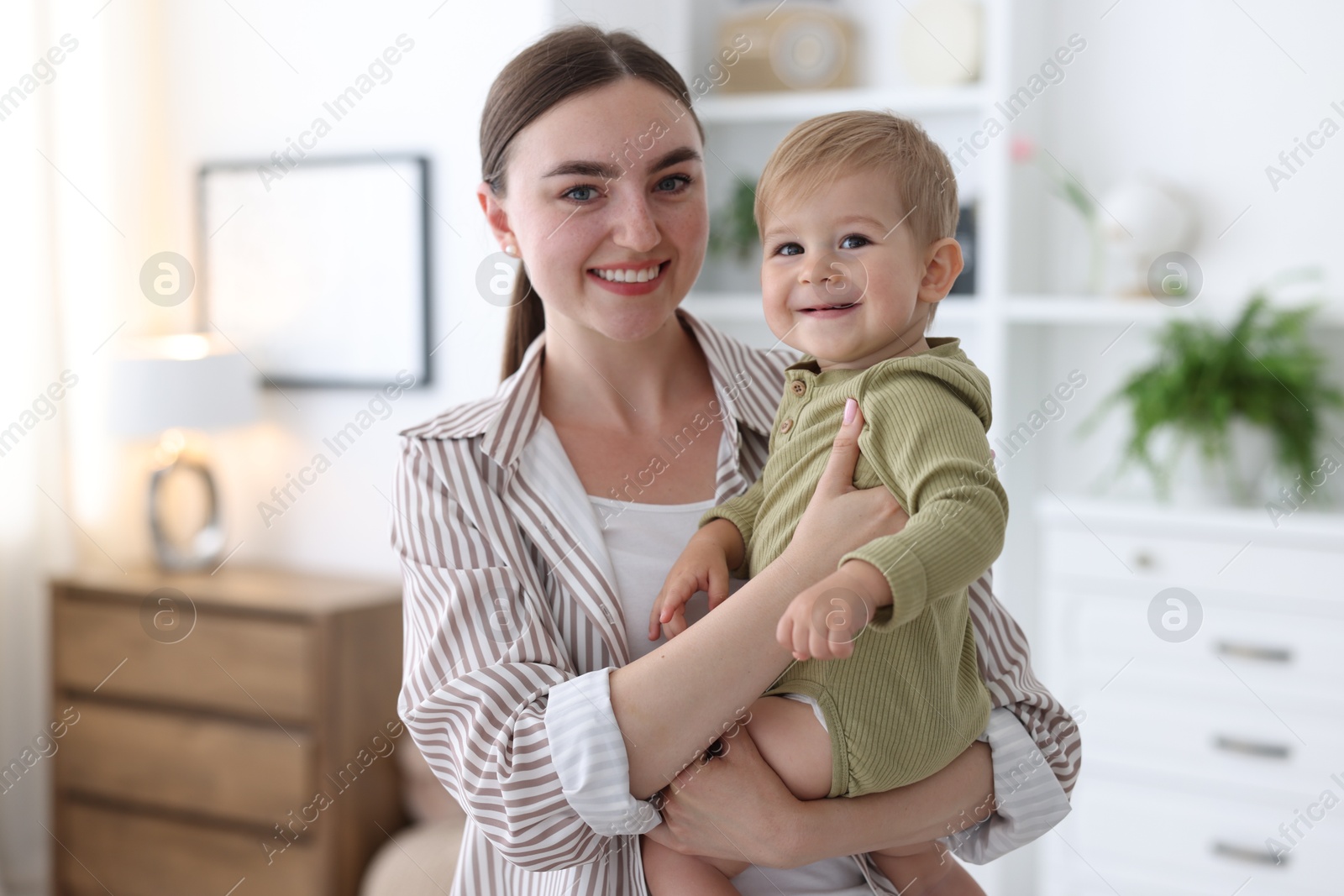 Photo of Mother with her cute little baby at home