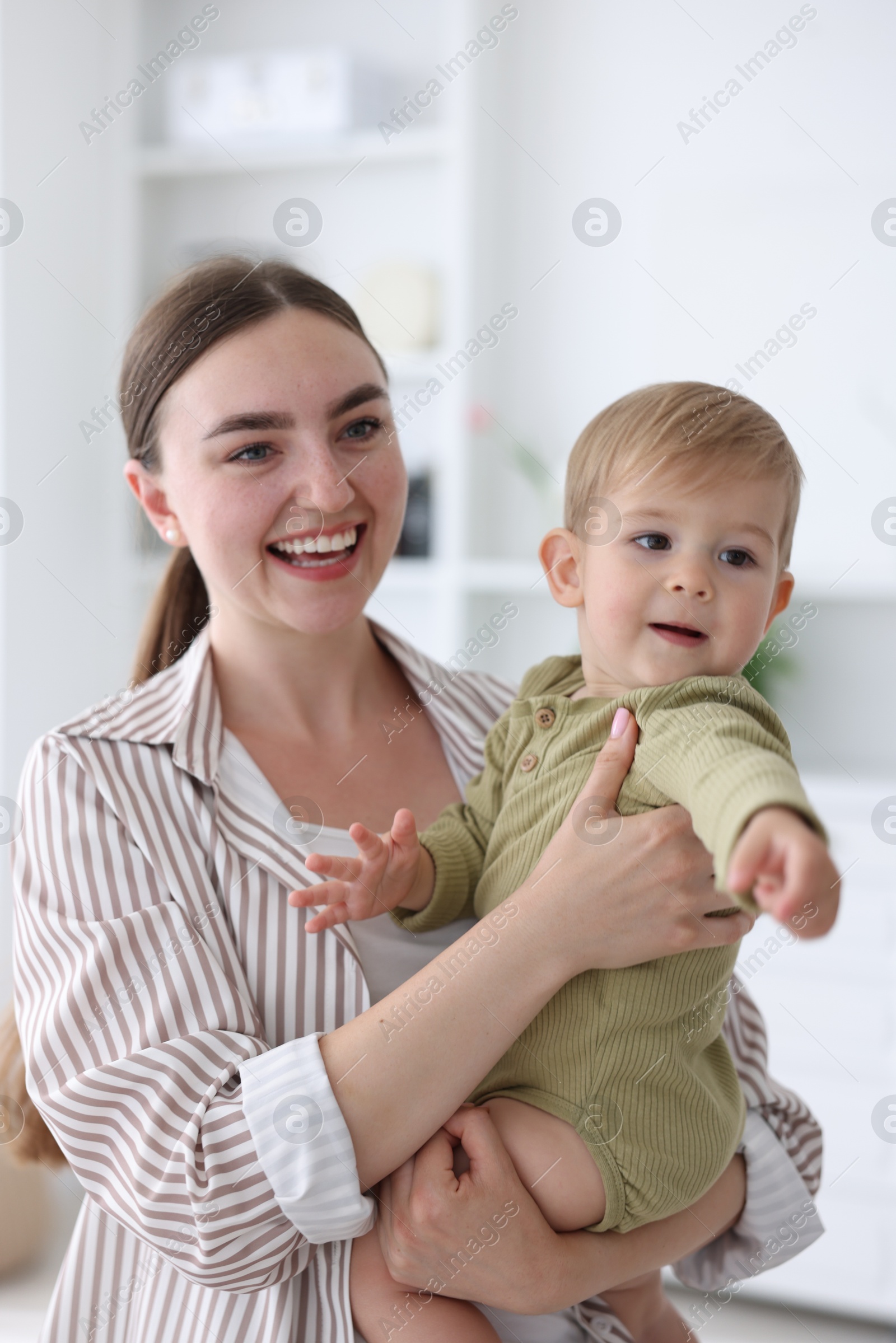 Photo of Mother with her cute little baby at home