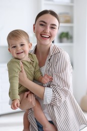 Photo of Mother with her cute little baby at home