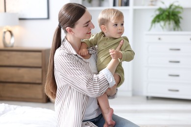 Photo of Mother with her cute little baby at home