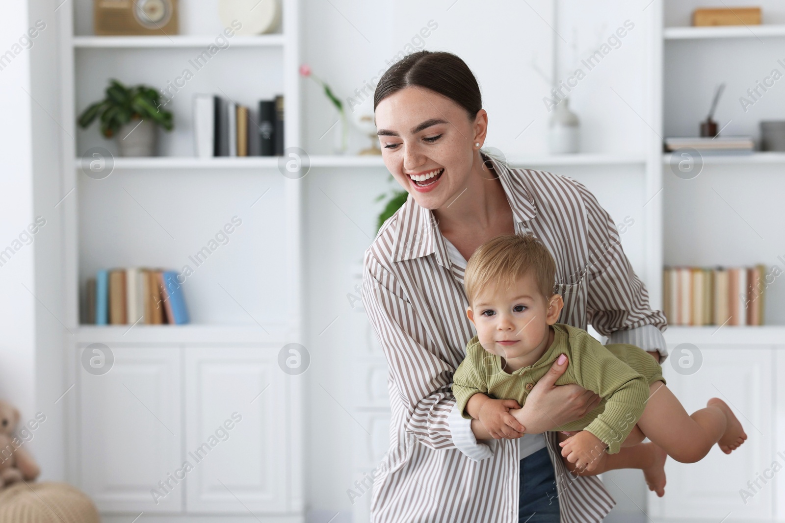 Photo of Mother with her cute little baby at home, space for text
