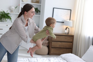 Photo of Mother with her cute little baby at home, space for text
