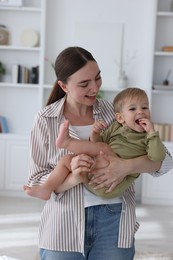 Photo of Mother with her cute little baby at home