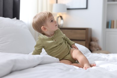 Photo of Cute little baby on bed at home