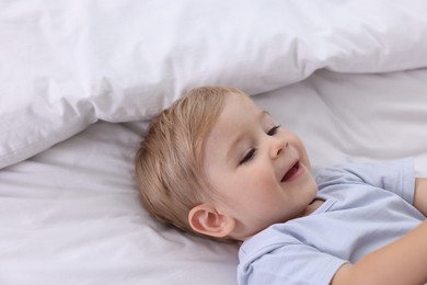 Photo of Cute little baby on bed at home