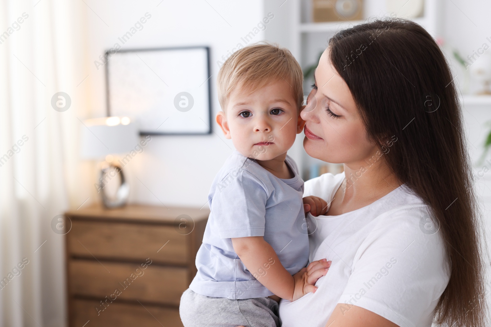 Photo of Mother with her cute little baby at home, space for text