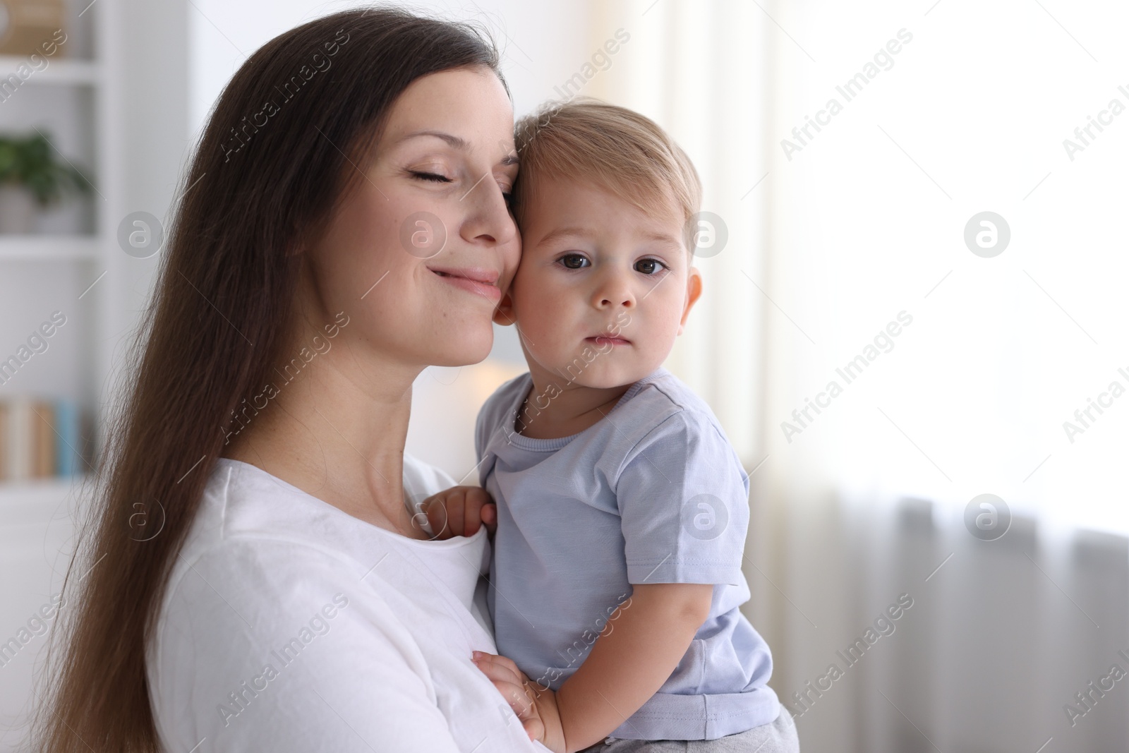 Photo of Mother with her cute little baby at home, space for text