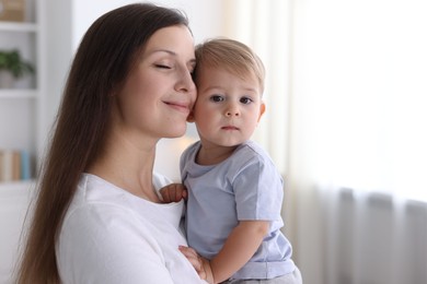 Photo of Mother with her cute little baby at home, space for text