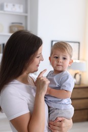Photo of Mother with her cute little baby at home