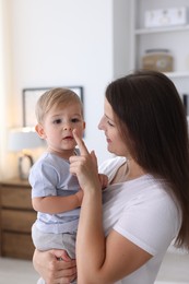 Photo of Mother with her cute little baby at home