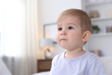 Photo of Portrait of cute little baby at home, space for text