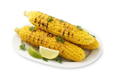 Photo of Tasty grilled corncobs with parsley and lime slices isolated on white